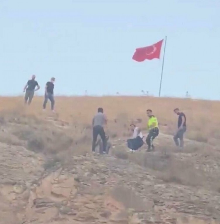 Türk bayrağını indirmeye kalkışan kişiyi linçten polis kurtardı